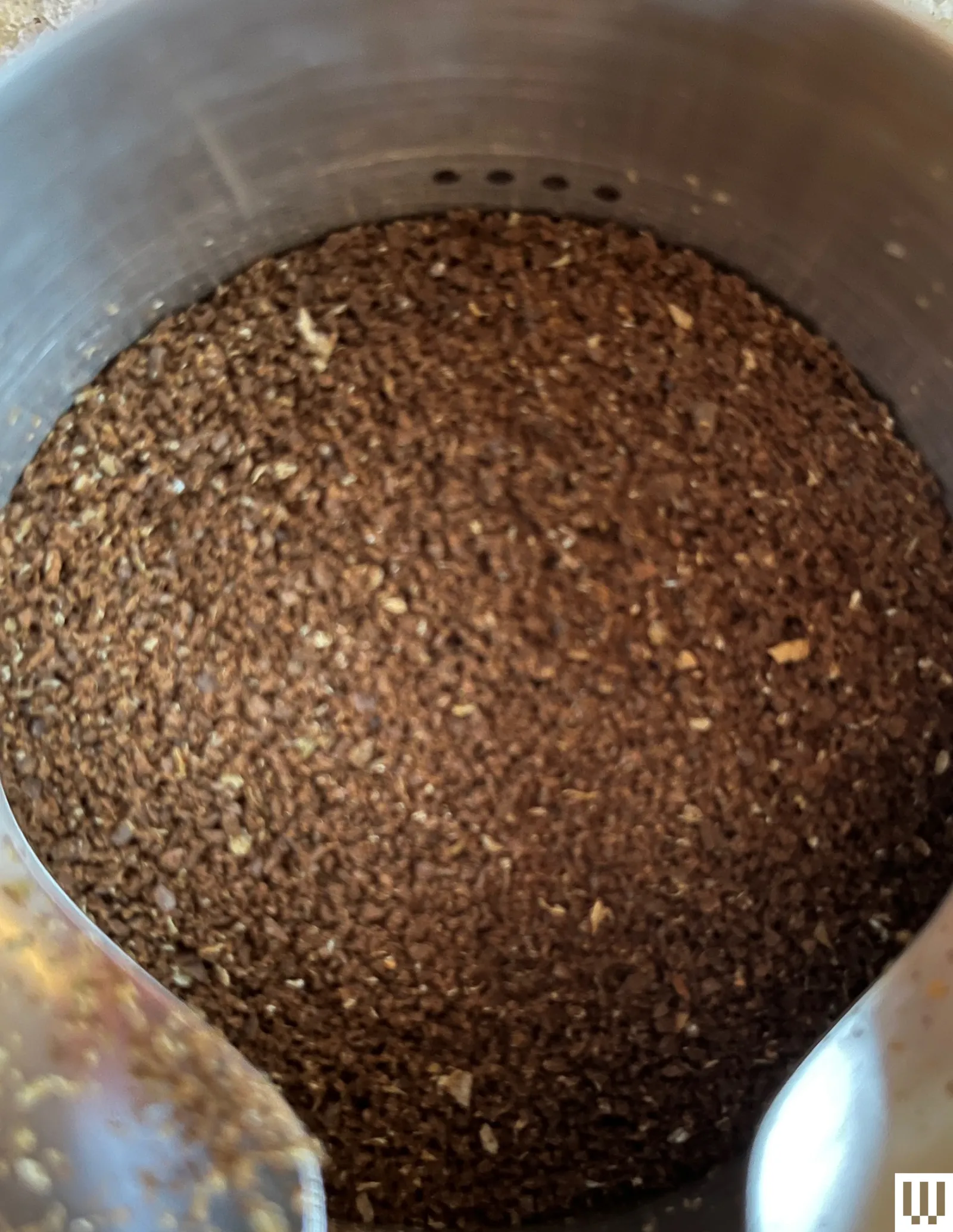 Closeup of coffee grounds in a metallic container