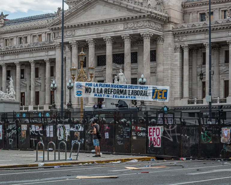 Police stand behind a metal barrier around Argentina's Congress
