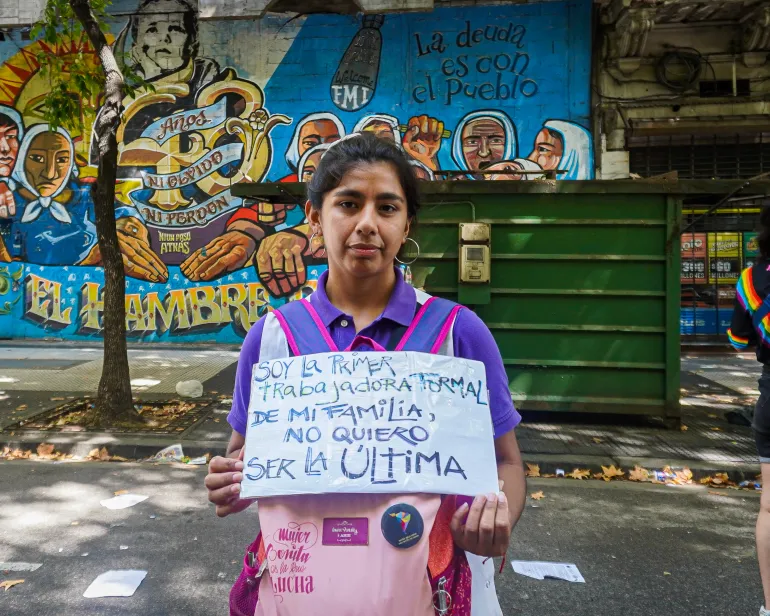 Gabriela Quiroz holds a sign to protest Argentina's labor reform