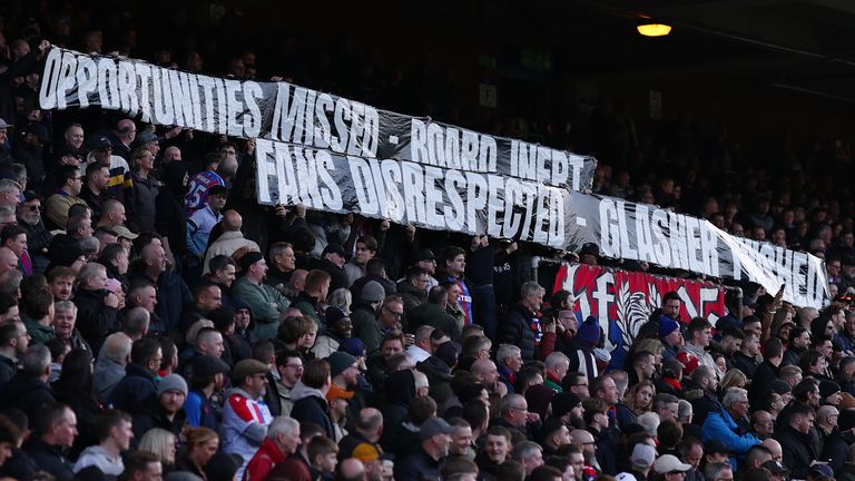 Crystal Palace fans hold up a banner against the club's board and manager Oliver Glasner