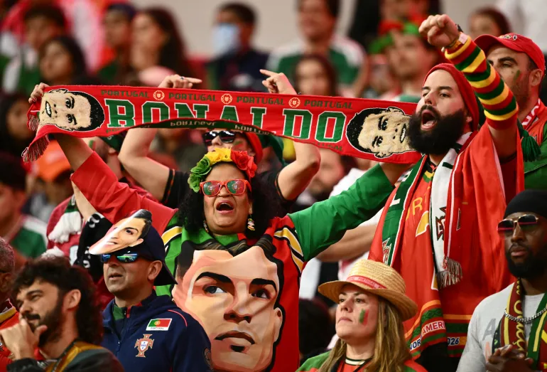A Portuguese fan shows a scarf depicting Portugal forward Cristiano Ronaldo during a friendly soccer match between Mexico and Portugal at the Banorte (formerly known as Azteca) stadium in Mexico City on March 28, 2026. (Photo by CARL DE SOUZA / AFP)