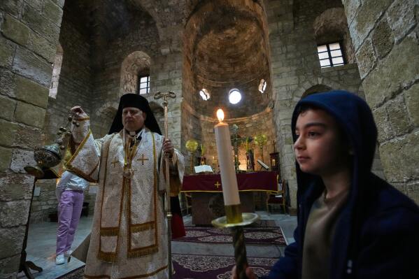 George Iskandar, the Metropolitan Archbishop of Tyre for the Melkite Greek Catholic Church presides over a Palm Sunday Mass at Saint Thomas Cathedral, in the southern port city of Tyre, south Lebanon, Sunday, March 29, 2026. (AP Photo/Hussein Malla)