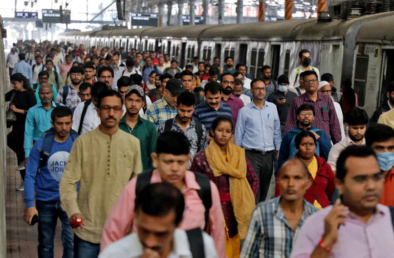 FILE PHOTO: Commuters walk on a platform after getting off a suburban train at a railway station in Mumbai, India January 21, 2023. REUTERS/Niharika Kulkarni/File Photo