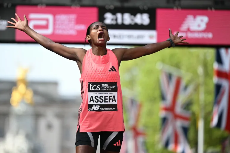 Ethiopia's Tigst Assefa reacts after crossing the line to win the women's race in a new world record for women at the 2026 London Marathon in central London on April 26, 2026. (Photo by JUSTIN TALLIS / AFP) / 