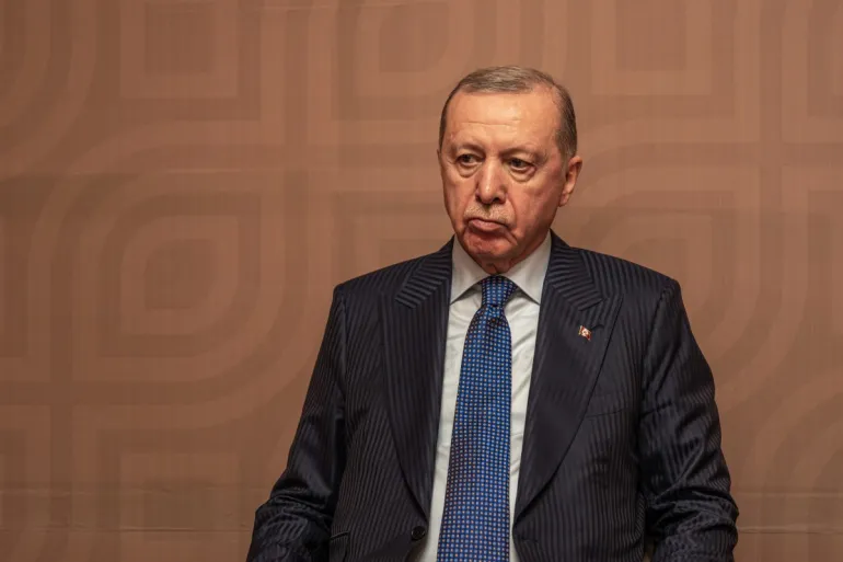 Turkey's President Recep Tayyip Erdogan attends a signing 