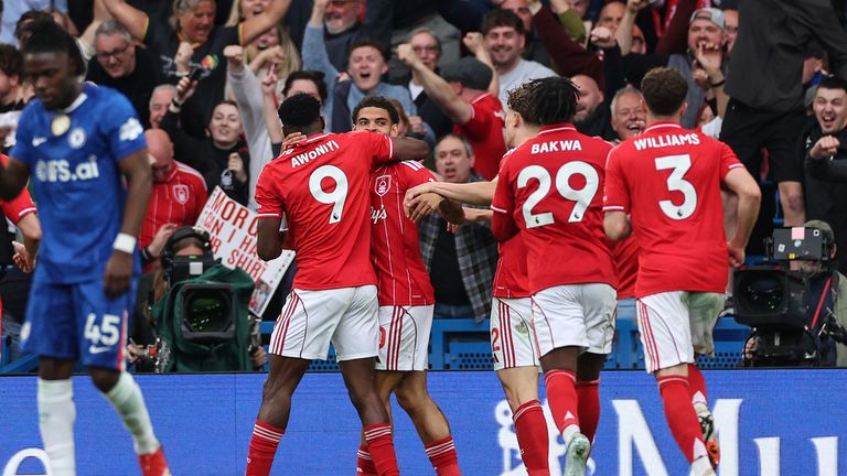 Nottingham Forest's Nigerian striker #09 Taiwo Awoniyi (L) celebrates with teammates after scoring his team's third goal during the English Premier League soccer match between Chelsea and Nottingham Forest at Stamford Bridge in London on May 4, 2026. (Photo by Adrian Dennis / AFP) / RESTRICTED TO EDITORIAL USE. Do not use unauthorized audio, video, data, fixture lists, club/league logos or 'live' services. Online in-game use limited to 120 images. An additional 40 images can be used in extra time. Not video emulation. Social media in-game use limited to 120 images. An additional 40 images can be used in extra time. Do not use in betting publications, games or single club/league/player publications. / 